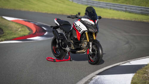 A 2024 Ducati Multistrada V4 RS adventure motorcycle speeding along a professional... free wallpaper