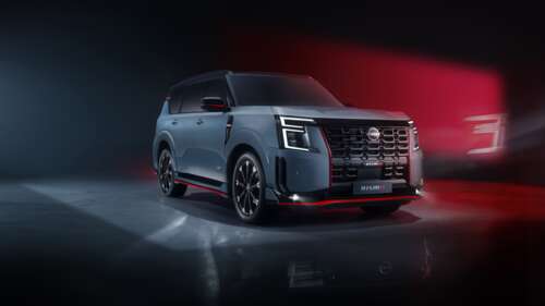 A metallic 2025 performance SUV driving on a futuristic city road at night with bright...