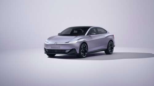 A group of sleek, high-tech electric cars driving through a modern city street, rendered... hd background