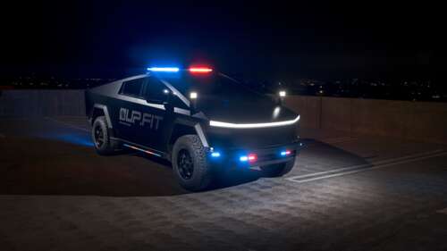 A Tesla Cybertruck modified with police decals, emergency lights, and patrol markings. wallpaper