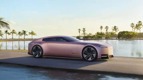 A sleek Jaguar Type 00 electric concept car parked on a sunlit Miami street, showcasing... free wallpaper