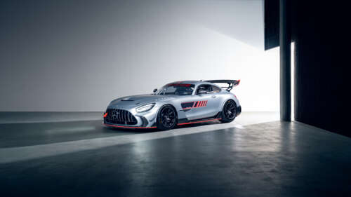 A Mercedes-AMG GT race car navigating a sharp turn on a professional motorsport track. wallpaper