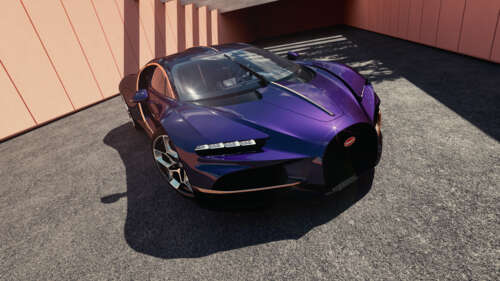 A metallic purple Bugatti Tourbillon hypercar parked in front of a luxury modern... free wallpaper