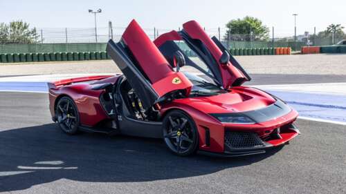 A high-performance red Ferrari F80 hypercar speeding along a professional race track. wallpaper