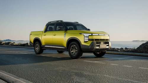 A futuristic and sleek 2025 electric SUV with aerodynamic curves and bright LED headlights. wallpaper