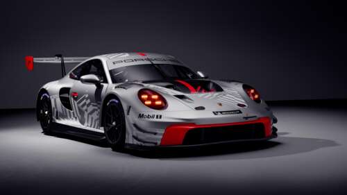 A sleek 2025 Porsche 911 GT3 R racing car presented in a dramatic, dark-themed setting... wallpaper