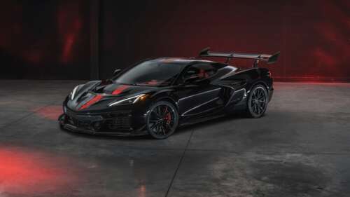 A dark, moody close-up of a black 2026 Chevrolet Corvette ZR1X in a low-light setting. free wallpaper