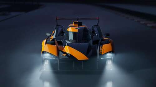 A vibrant orange McLaren Project Endurance Le Mans Hypercar captured during a night... wallpaper