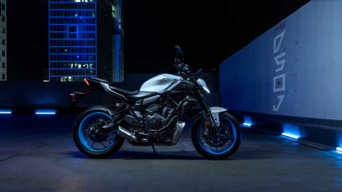 A sleek 2025 Yamaha MT-07 motorcycle parked in a dark, atmospheric night setting... free wallpaper