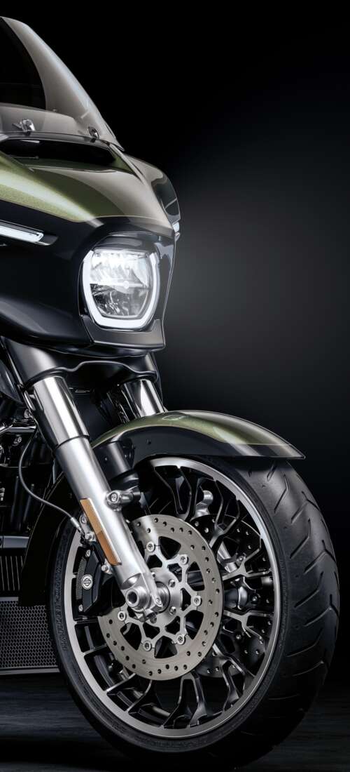 A high-detail view of a 2026 Harley-Davidson Street Glide cruiser motorcycle set... Motorola Moto X70 Air Pro free background