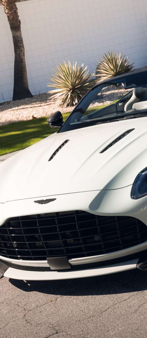 A high-resolution, detailed view of a luxury Aston Martin DB12 S Volante convertible... Xiaomi Redmi 14C 5G download free phone wallpaper