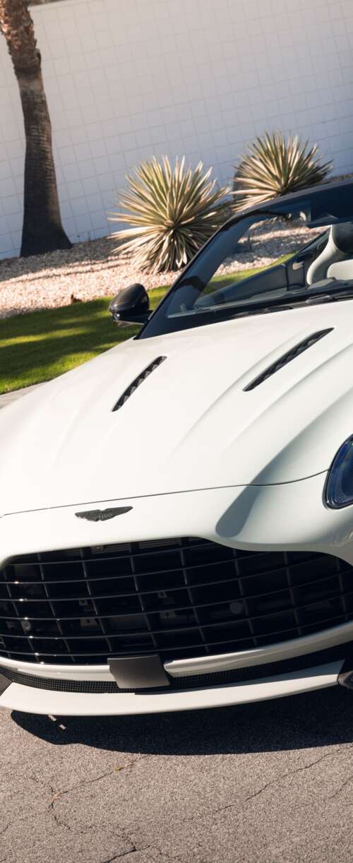 A high-resolution, detailed view of a luxury Aston Martin DB12 S Volante convertible... Samsung Galaxy Z Flip7 FE wallpaper
