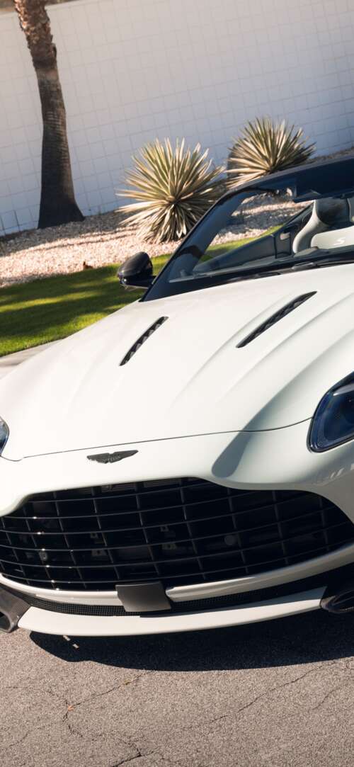 A high-resolution, detailed view of a luxury Aston Martin DB12 S Volante convertible... Xiaomi Redmi 15 4G hand phone wallpaper