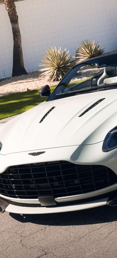 A high-resolution, detailed view of a luxury Aston Martin DB12 S Volante convertible... Motorola Moto X70 Air Pro wallpaper