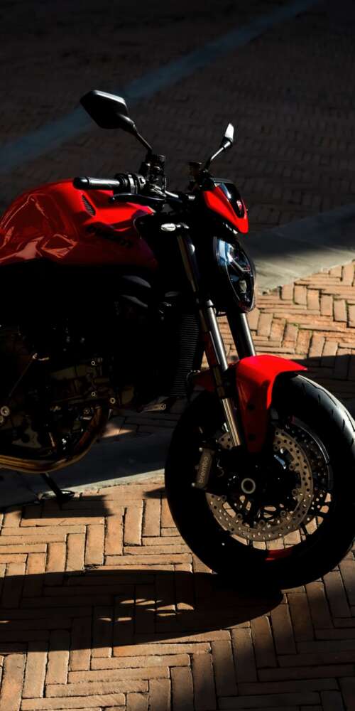 A sleek and aggressive 2026 Ducati Monster V2 motorcycle featuring modern sports... free background images