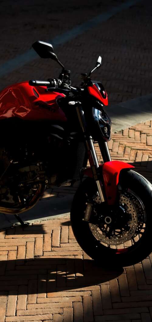 A sleek and aggressive 2026 Ducati Monster V2 motorcycle featuring modern sports... Oppo A6k 4G mobile wallpaper