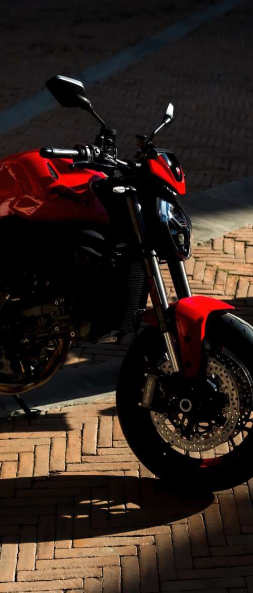 A sleek and aggressive 2026 Ducati Monster V2 motorcycle featuring modern sports... nubia Flip 3 free wallpaper