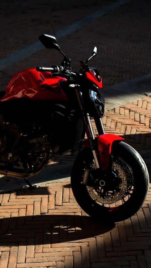 A sleek and aggressive 2026 Ducati Monster V2 motorcycle featuring modern sports... Apple iPhone SE 2022 cell phone backgrounds free