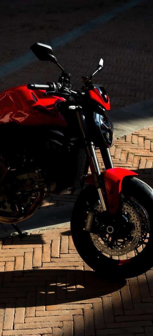 A sleek and aggressive 2026 Ducati Monster V2 motorcycle featuring modern sports... Oppo Find X9 wallpaper download