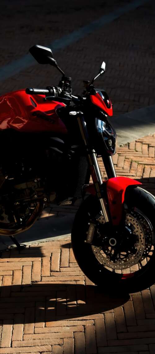 A sleek and aggressive 2026 Ducati Monster V2 motorcycle featuring modern sports... Blackview XPLORE 1 Pro free background images