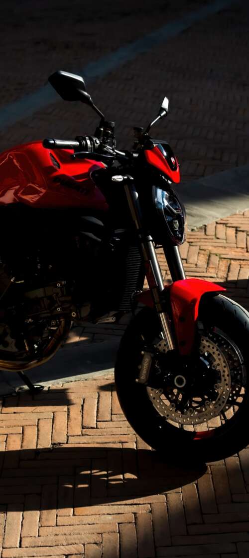 A sleek and aggressive 2026 Ducati Monster V2 motorcycle featuring modern sports... Vivo iQOO Z10 Turbo