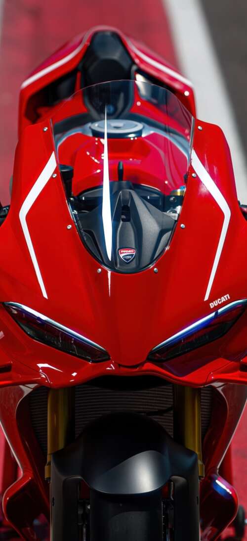 A sleek, red 2026 Ducati Panigale V4 R sports motorcycle in high detail. Oppo K13 Turbo lock screen wallpaper