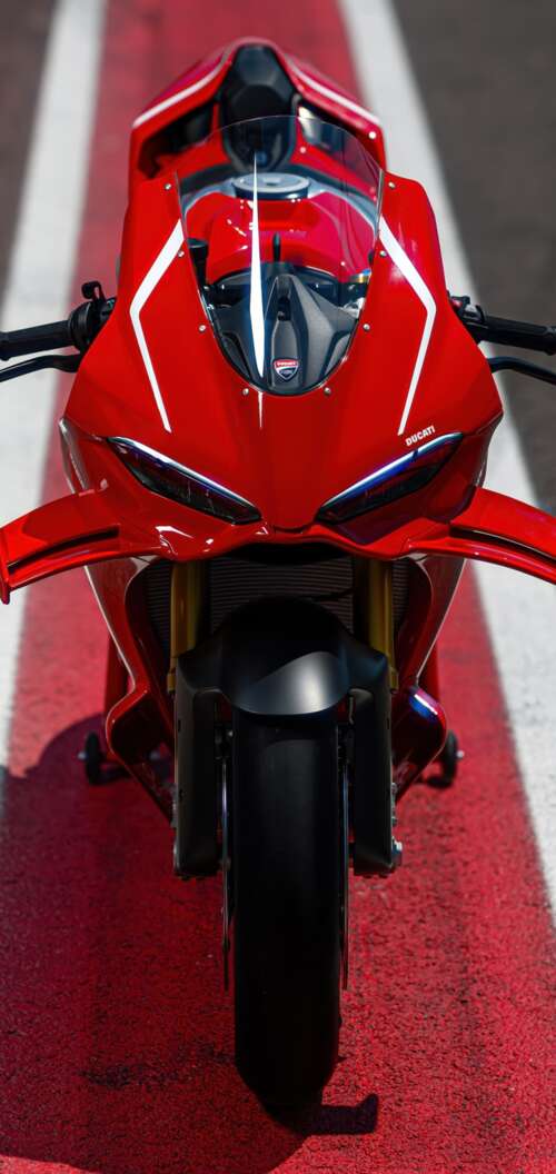 A high-detail view of a red 2026 Ducati Panigale V4 R sports motorcycle featuring... realme C83 5G download free phone wallpaper