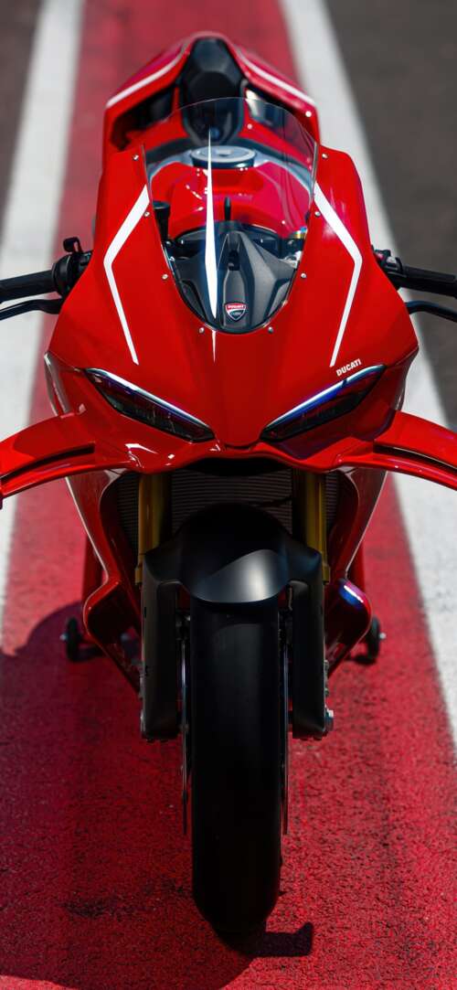A high-detail view of a red 2026 Ducati Panigale V4 R sports motorcycle featuring... Xiaomi Redmi 15 4G pictures for wallpaper