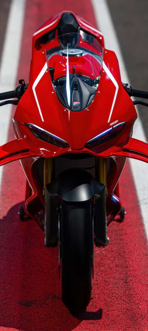 A high-detail view of a red 2026 Ducati Panigale V4 R sports motorcycle featuring... Vivo iQOO Z10 Turbo hd background