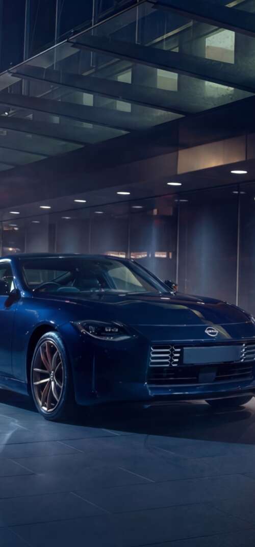 A sleek and detailed view of the 2026 Nissan Z Heritage Edition sports car. Samsung Galaxy S26 Ultra download free wallpaper for phone