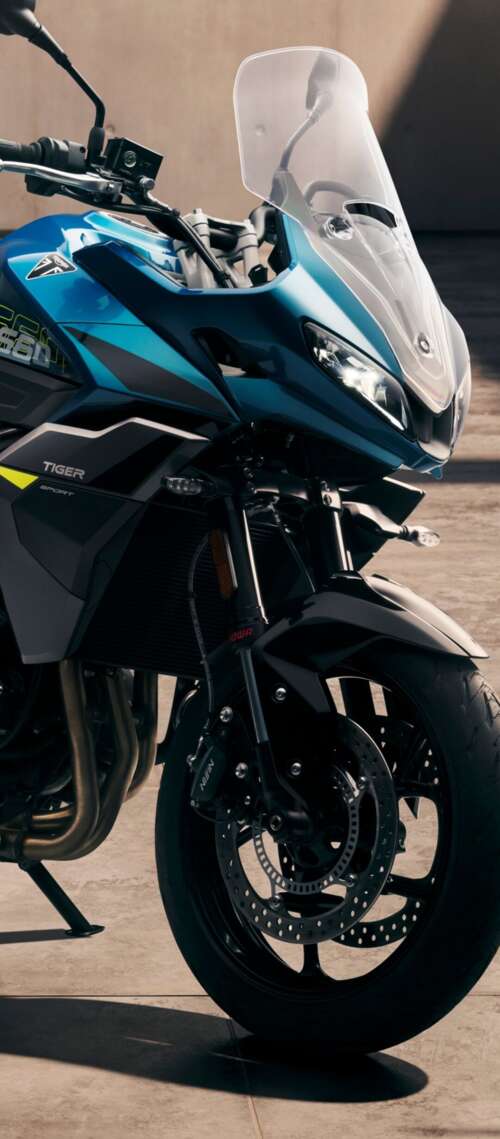 Close-up view of the 2026 Triumph Tiger Sport 660 adventure touring motorcycle Blackview XPLORE 1 Pro hand phone wallpaper