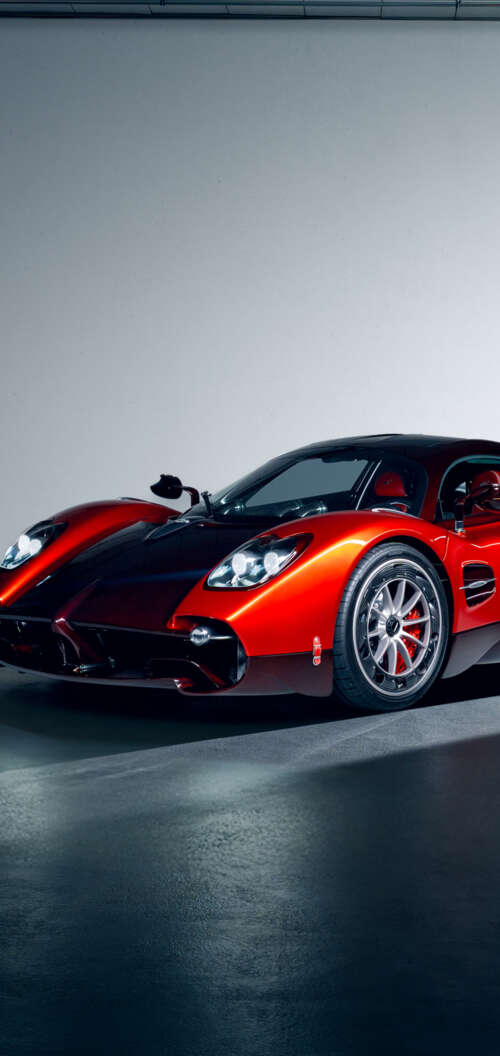 A high-performance red Pagani Utopia hypercar featuring sleek aerodynamic lines and... realme C83 5G