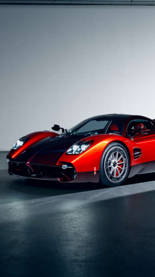 A high-performance red Pagani Utopia hypercar featuring sleek aerodynamic lines and... Apple iPhone SE 2022 free hd wallpapers