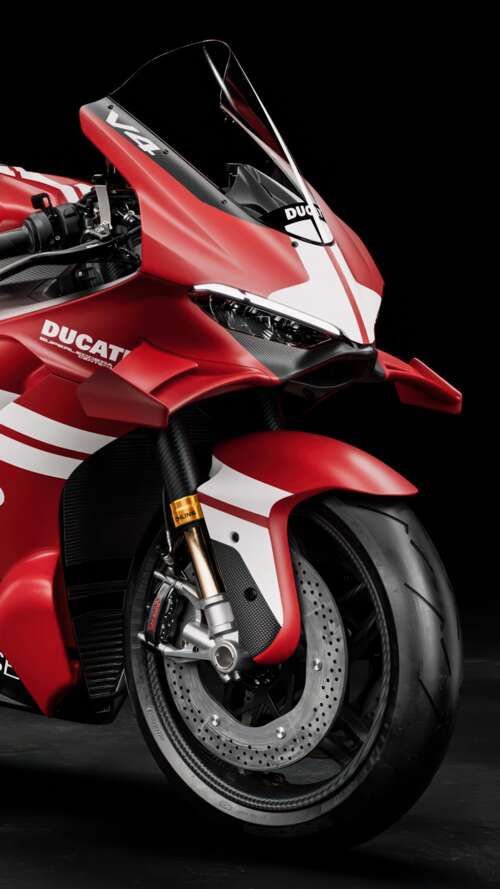 A cinematic close-up of a Ducati Superleggera V4 Centenario sports motorcycle against... free background images