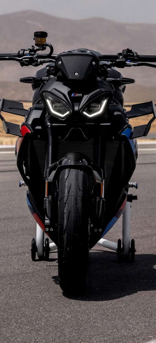 A high-detail shot of the 2026 BMW M 1000 R motorcycle parked on asphalt. Oppo K13 Turbo Pro lock screen wallpaper