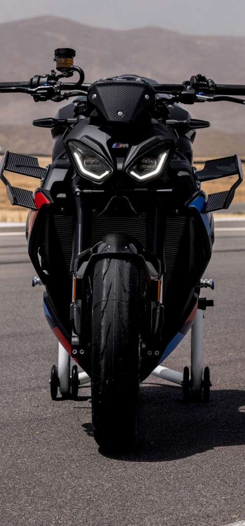 A high-detail shot of the 2026 BMW M 1000 R motorcycle parked on asphalt. Samsung Galaxy S26 Ultra cell phone backgrounds free