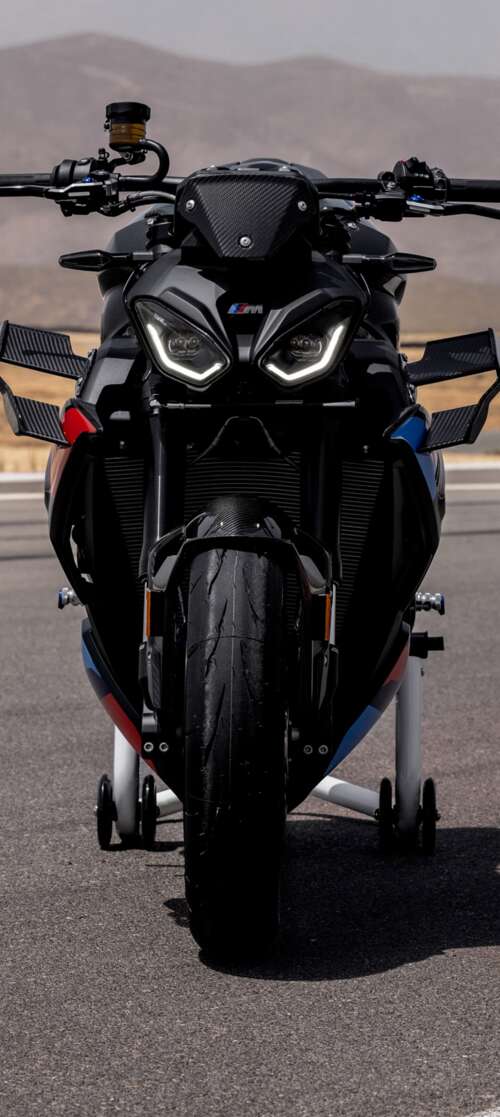 A high-detail shot of the 2026 BMW M 1000 R motorcycle parked on asphalt. Motorola Edge (2025) wallpapers for android