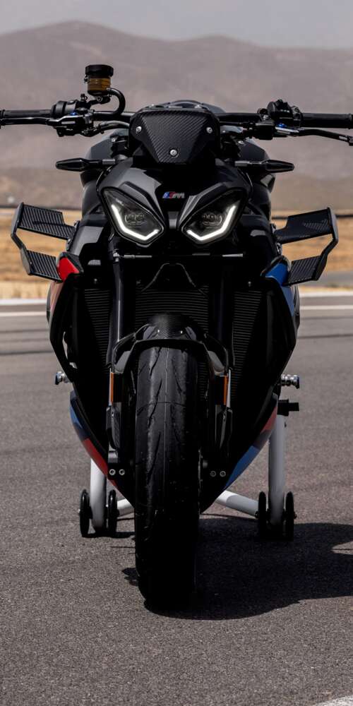 A high-detail shot of the 2026 BMW M 1000 R motorcycle parked on asphalt. Ulefone Rugking 2 Pro