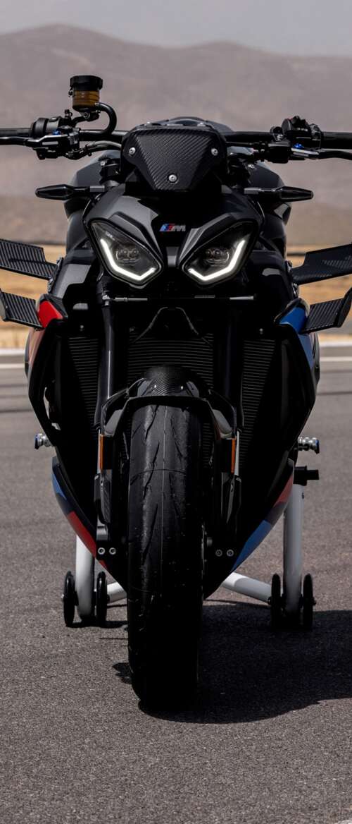 A high-detail shot of the 2026 BMW M 1000 R motorcycle parked on asphalt. nubia Flip 3 free background images