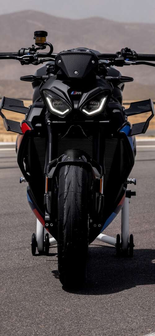 A high-detail shot of the 2026 BMW M 1000 R motorcycle parked on asphalt. Xiaomi Redmi 15 4G download free wallpaper for phone