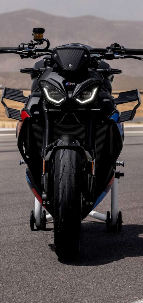 A high-detail shot of the 2026 BMW M 1000 R motorcycle parked on asphalt. Oppo A6k 4G free hd wallpapers
