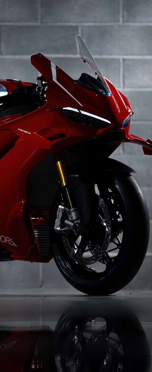 A sleek, red 2026 Ducati Panigale V4 R performance motorcycle with aerodynamic bodywork. Samsung Galaxy Z Flip7 FE hd background