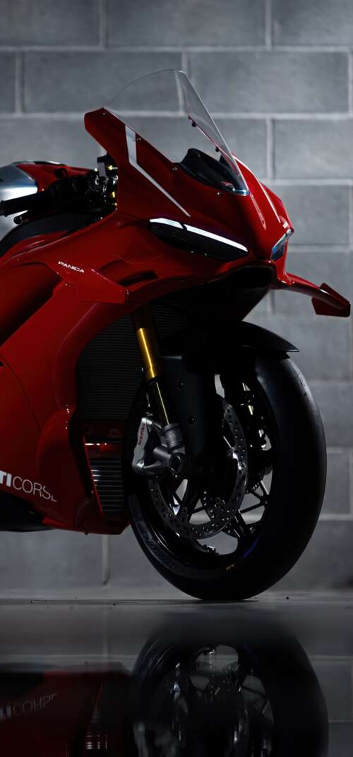 A sleek, red 2026 Ducati Panigale V4 R performance motorcycle with aerodynamic bodywork. Samsung Galaxy S26 Ultra high definition wallpaper