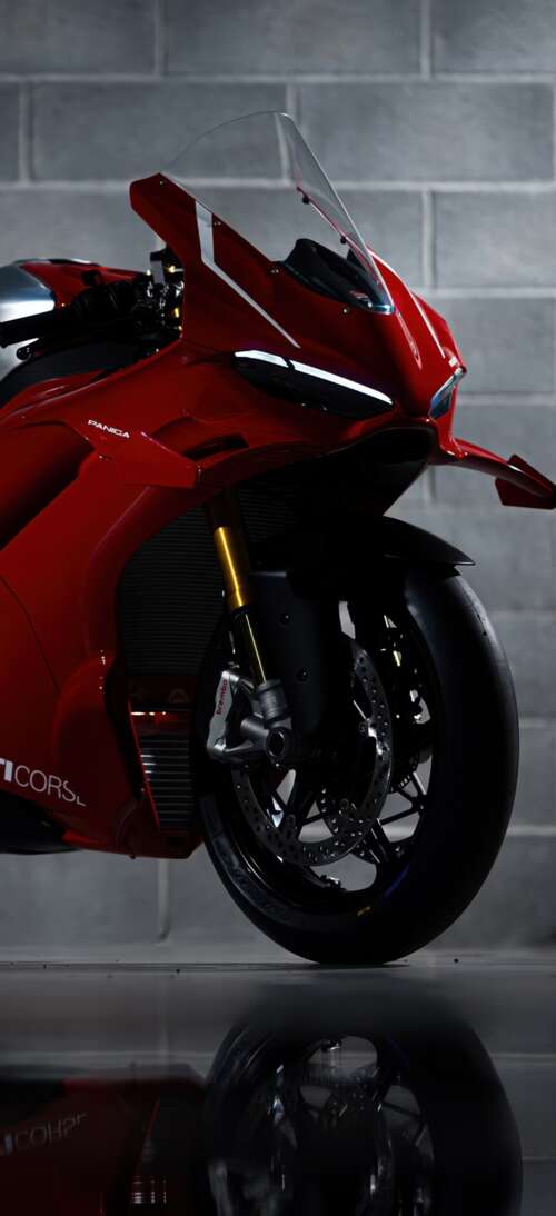 A sleek, red 2026 Ducati Panigale V4 R performance motorcycle with aerodynamic bodywork. realme GT 7T free wallpaper
