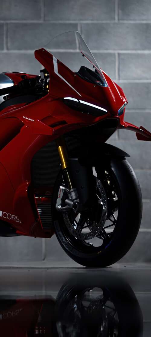 A sleek, red 2026 Ducati Panigale V4 R performance motorcycle with aerodynamic bodywork. Vivo iQOO Z10 Turbo hand phone wallpaper