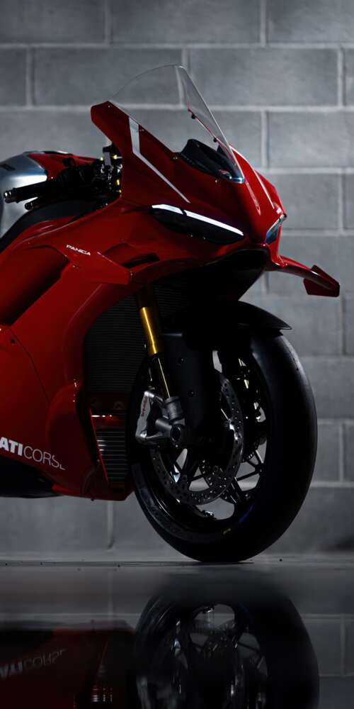 A sleek, red 2026 Ducati Panigale V4 R performance motorcycle with aerodynamic bodywork. Ulefone Rugking 2 Pro background images hd