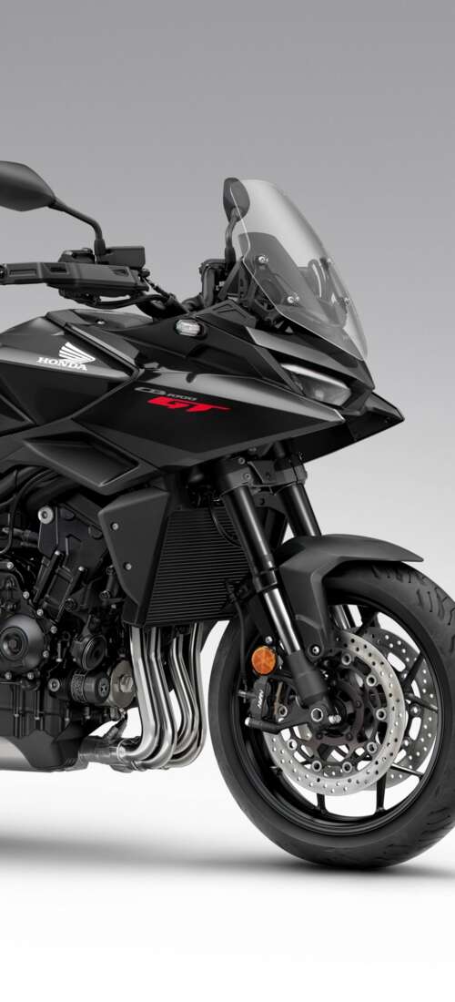 A sleek and modern black 2026 Honda CB1000GT touring motorcycle with a glossy finish. Oppo Find X9 free background