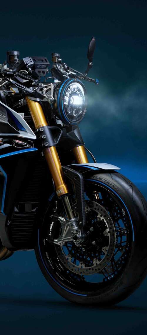 A sleek, dark blue 2026 MV Agusta Rush Titanio naked motorcycle with high-end finishes. Motorola Moto G06 Power hand phone wallpaper