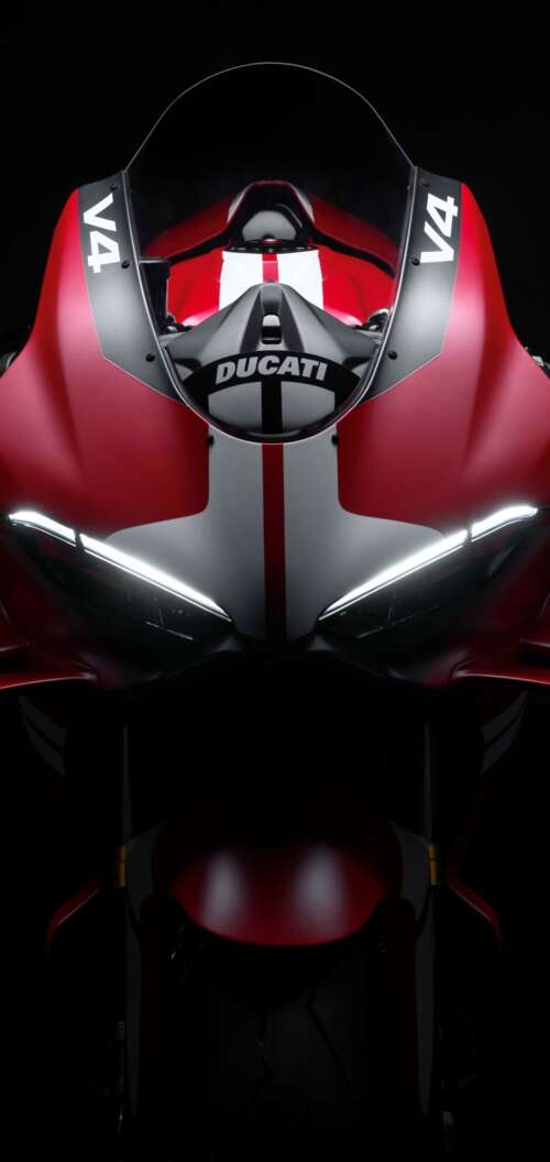 Cinematic close-up of a Ducati Superleggera V4 Centenario sports bike in a dark studio... hd background