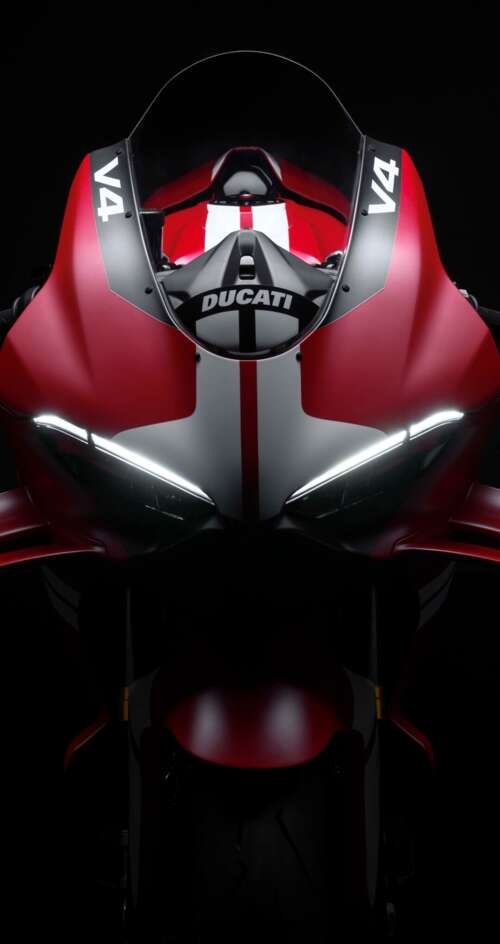 Cinematic close-up of a Ducati Superleggera V4 Centenario sports bike in a dark studio... Sharp Aquos C10 hd background